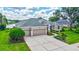 Well-maintained home features a three-car garage, lush landscaping, and a serene water view at 11250 Rivers Bluff Cir, Lakewood Ranch, FL 34202