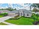 Stunning single-story home with a three-car garage, lush landscaping, and a well-manicured lawn at 11250 Rivers Bluff Cir, Lakewood Ranch, FL 34202
