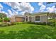 Single-story home showcasing the lush green lawn, landscaped garden beds, and well-maintained exterior at 11250 Rivers Bluff Cir, Lakewood Ranch, FL 34202