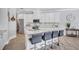 Modern kitchen features white cabinets, granite countertops, stainless steel appliances, and a large island with seating at 11250 Rivers Bluff Cir, Lakewood Ranch, FL 34202