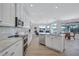Bright, open kitchen with stainless steel appliances flowing into the living and dining areas at 11250 Rivers Bluff Cir, Lakewood Ranch, FL 34202