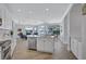 Open kitchen with stainless steel appliances and island leading to dining and living areas at 11250 Rivers Bluff Cir, Lakewood Ranch, FL 34202