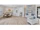 Open-concept living room with dining area, tile floors, and modern fireplace feature at 11250 Rivers Bluff Cir, Lakewood Ranch, FL 34202