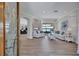 Open-concept living room with stone fireplace and views of the pool and lake through sliding glass doors at 11250 Rivers Bluff Cir, Lakewood Ranch, FL 34202