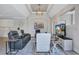 Open-concept living room featuring a tray ceiling, modern lighting, and neutral color palette at 11250 Rivers Bluff Cir, Lakewood Ranch, FL 34202