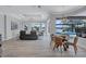 Open floor plan flows from a living area with a water view to a dining area and pool view at 11250 Rivers Bluff Cir, Lakewood Ranch, FL 34202