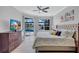 Comfortable main bedroom with a tray ceiling, neutral decor, and sliding doors to the pool area at 11250 Rivers Bluff Cir, Lakewood Ranch, FL 34202