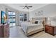 Spacious main bedroom with a tray ceiling, neutral decor, and views of the pool and lake at 11250 Rivers Bluff Cir, Lakewood Ranch, FL 34202