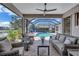 Covered patio with comfortable seating and a view of the pool and scenic lake at 11250 Rivers Bluff Cir, Lakewood Ranch, FL 34202