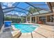 Beautiful pool with a screened enclosure, brick pavers, and an outdoor dining area at 11250 Rivers Bluff Cir, Lakewood Ranch, FL 34202