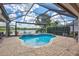 Beautiful in-ground pool with an integrated spa overlooking a tranquil lake and lush surroundings at 11250 Rivers Bluff Cir, Lakewood Ranch, FL 34202