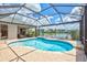 Inviting in-ground pool with an integrated spa overlooking a serene lake and blue skies at 11250 Rivers Bluff Cir, Lakewood Ranch, FL 34202