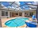 Spacious pool area featuring a screened enclosure, brick pavers, and multiple seating areas at 11250 Rivers Bluff Cir, Lakewood Ranch, FL 34202