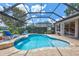 Inviting pool area with a screened enclosure, brick pavers, and lush landscaping at 11250 Rivers Bluff Cir, Lakewood Ranch, FL 34202