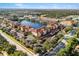 Gorgeous aerial view of a lakeside community, showing condo buildings and surrounding roads at 150 L Pavia Blvd # 13, Venice, FL 34292