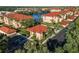 Scenic aerial view of residences, a lake, and parking spots in a beautiful community at 150 L Pavia Blvd # 13, Venice, FL 34292