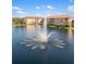Aerial view of community with a lake and buildings featuring a rainbow in the water fountain at 150 L Pavia Blvd # 13, Venice, FL 34292