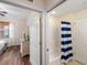 Bathroom featuring white shower and tub, separated by a doorway from the bedroom at 150 L Pavia Blvd # 13, Venice, FL 34292