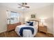 Cozy bedroom with ceiling fan, side tables, and large window at 150 L Pavia Blvd # 13, Venice, FL 34292