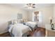 Bright bedroom with twin beds, ceiling fan, wood floors, and light neutral walls at 150 L Pavia Blvd # 13, Venice, FL 34292