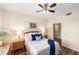 Bedroom with ceiling fan and access to bathroom at 150 L Pavia Blvd # 13, Venice, FL 34292
