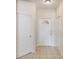 Interior home entrance showcasing white walls and doors, and tiled flooring at 150 L Pavia Blvd # 13, Venice, FL 34292