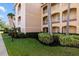 Exterior of property featuring a lawn and manicured bushes and shrubbery at 150 L Pavia Blvd # 13, Venice, FL 34292