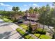Exterior street view of community with palm trees, landscaping, and car parking at 150 L Pavia Blvd # 13, Venice, FL 34292