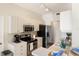 Bright kitchen with white cabinetry and stainless steel appliances at 150 L Pavia Blvd # 13, Venice, FL 34292