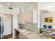 Kitchen with white cabinetry open to the living room at 150 L Pavia Blvd # 13, Venice, FL 34292