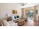 Cozy living room with stylish furnishings and serene views from sliding glass doors at 150 L Pavia Blvd # 13, Venice, FL 34292
