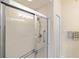 Bright bathroom shower featuring a sliding glass door, and a rainfall shower head at 150 L Pavia Blvd # 13, Venice, FL 34292