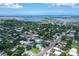 Beautiful home surrounded by lush trees and neighborhood, with a glimpse of the bay at 1738 Siesta Dr, Sarasota, FL 34239