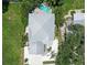 Aerial view of home showcasing roof, driveway, and lush surrounding landscape at 1738 Siesta Dr, Sarasota, FL 34239