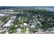 Aerial view showcasing a house in a neighborhood with tree coverage near commercial area at 1738 Siesta Dr, Sarasota, FL 34239