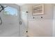 Shower with glass door and ocean print at 1738 Siesta Dr, Sarasota, FL 34239