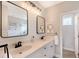 A well-lit bathroom with double sinks, modern mirrors, and a storage cubby at 1738 Siesta Dr, Sarasota, FL 34239