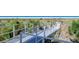 White railings guide the way to the beach over a wooden bridge, surrounded by lush greenery and beach foliage at 1738 Siesta Dr, Sarasota, FL 34239