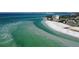 An aerial photograph captures the coastline and shoreline, with sandbars and ocean hues at 1738 Siesta Dr, Sarasota, FL 34239