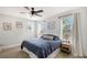 Cozy bedroom featuring a ceiling fan, natural light, and shiplap accent wall at 1738 Siesta Dr, Sarasota, FL 34239