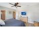 This bedroom has a ceiling fan, attached bathroom and TV on the wall at 1738 Siesta Dr, Sarasota, FL 34239