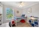 Bright bedroom featuring a loft bed, a view of palm trees, a ceiling fan and nautical themed decor at 1738 Siesta Dr, Sarasota, FL 34239