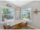 Bright dining area with pool view and decorative light fixture above the table at 1738 Siesta Dr, Sarasota, FL 34239