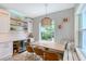 Bright dining area with modern light fixture, bar area, wine storage, and natural light at 1738 Siesta Dr, Sarasota, FL 34239