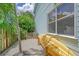 Exterior view of home featuring gravel area with kayak storage and greenery at 1738 Siesta Dr, Sarasota, FL 34239