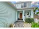 Inviting front entrance with stone walkway, a decorative wooden door, and vibrant landscaping at 1738 Siesta Dr, Sarasota, FL 34239