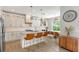 Bright and airy kitchen with white cabinetry, modern appliances, and a large island with seating, and adjacent dining area at 1738 Siesta Dr, Sarasota, FL 34239