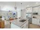 Modern kitchen boasts a large center island, stainless appliances, and open access to the living room at 1738 Siesta Dr, Sarasota, FL 34239