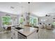 Open floor plan showcases the kitchen island, dining area and living space at 1738 Siesta Dr, Sarasota, FL 34239