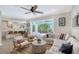 Open-concept living area featuring stylish furniture, and a seamless transition to an outdoor patio with a pool at 1738 Siesta Dr, Sarasota, FL 34239